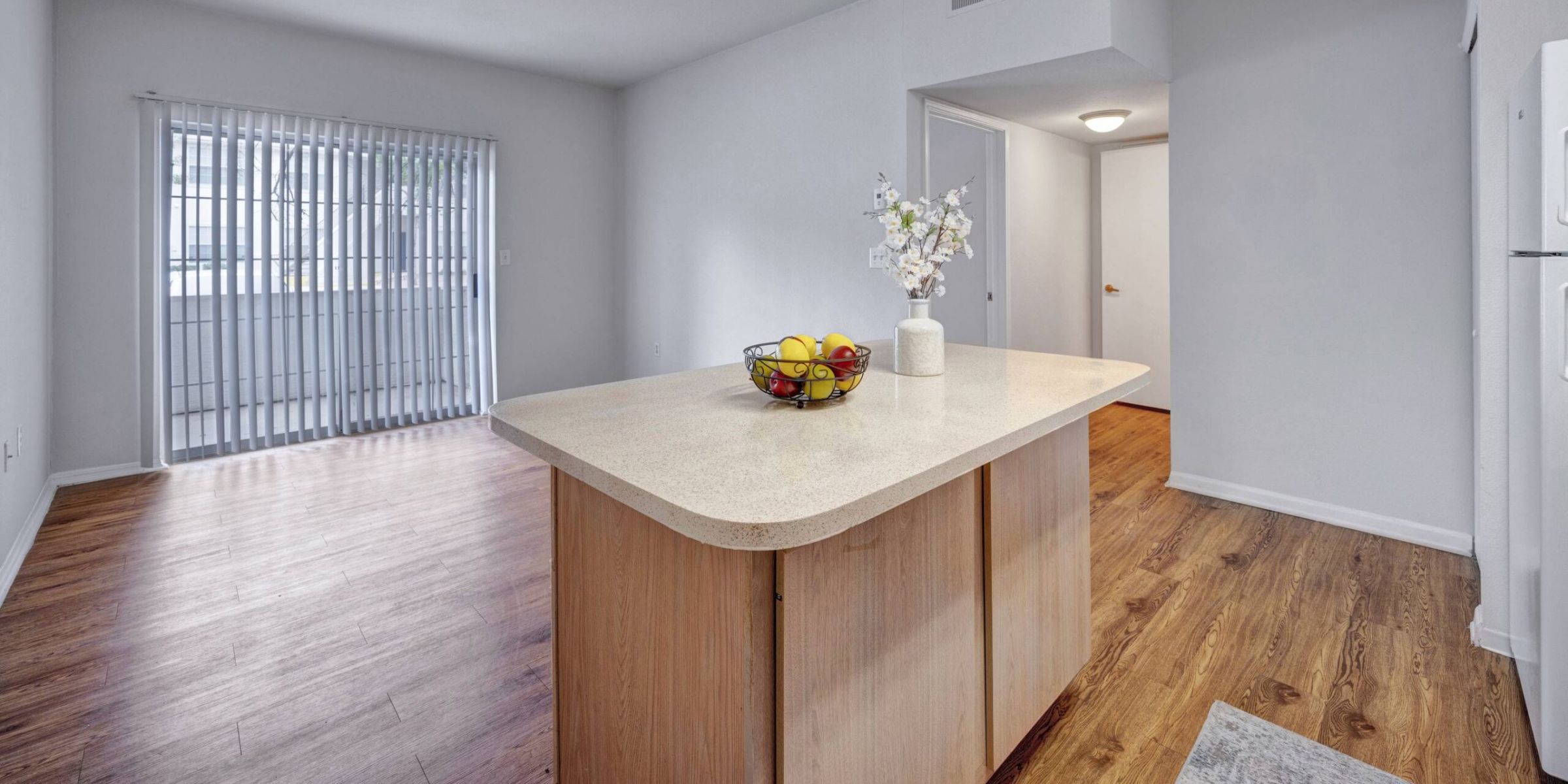 Luxury apartment living room with large windows, wood style floors and contemporary furniture at The Civic at Frisco Square